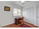 Comfortable bedroom with wood floors, built-in closets, and a classic desk situated near a bright window at 134 Marsh View Villas, Folly Beach, SC 29439