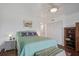 Well lit bedroom with a ceiling fan, a comfortable bed and a small cabinet at 134 Marsh View Villas, Folly Beach, SC 29439