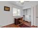 Bright bedroom with wood floors, featuring a desk and a built-in closet with drawers and shelving at 134 Marsh View Villas, Folly Beach, SC 29439