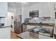 Modern kitchen featuring stainless steel appliances, granite countertops, and a in-unit washer/dryer at 134 Marsh View Villas, Folly Beach, SC 29439