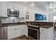 Modern kitchen featuring stainless steel appliances, granite countertops, and ample natural light at 134 Marsh View Villas, Folly Beach, SC 29439