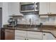 Updated kitchen features stainless steel appliances, granite countertops, and ample cabinet space at 134 Marsh View Villas, Folly Beach, SC 29439