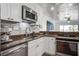 Modern kitchen featuring stainless steel appliances, granite countertops, and ample natural light at 134 Marsh View Villas, Folly Beach, SC 29439