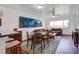 Open concept living area with wood floors, stylish sofas, matching dining set, and bright window lighting at 134 Marsh View Villas, Folly Beach, SC 29439