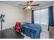 Functional bedroom with a dark wood desk, a red and black chair, and a window with natural light at 138 Hidden Palms Blvd, Summerville, SC 29485