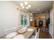 Bright dining space with hardwood floors, stylish lighting, and a convenient pass-through to the well-equipped kitchen at 138 Hidden Palms Blvd, Summerville, SC 29485