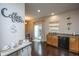 Bright kitchen with hardwood floors, stainless steel appliances, granite countertops, and a charming coffee bar at 138 Hidden Palms Blvd, Summerville, SC 29485