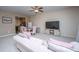 Comfortable living room with pink couch, dining area, and a large television at 138 Hidden Palms Blvd, Summerville, SC 29485
