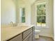 Bright bathroom featuring a vanity with gray cabinets, a large mirror, and natural light at 138 Maritime Way, Summerville, SC 29485