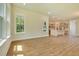 Spacious living room with wood floors leads to a kitchen with gray cabinets and stainless steel appliances at 138 Maritime Way, Summerville, SC 29485