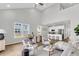 Bright living room with soaring ceilings, sleek furniture, and an open-concept kitchen, perfect for modern living at 139 Cantona Dr, Summerville, SC 29483