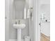 Stylish powder room with pedestal sink, gold fixtures, mirror, and neutral decor at 139 Cantona Dr, Summerville, SC 29483