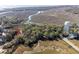 High angle view of marsh front neighborhood including lush tree growth and winding rivers at 1409 Dune Loft Villas, Seabrook Island, SC 29455