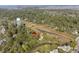 High angle shot of marsh-front neighborhood next to a water tower with dense trees all around at 1409 Dune Loft Villas, Seabrook Island, SC 29455