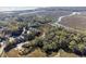 Picturesque aerial view highlights the waterfront home amidst a canopy of trees at 1409 Dune Loft Villas, Seabrook Island, SC 29455