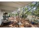 Inviting back patio area, perfect for relaxing with seating and scenic views of the surrounding trees and waterways at 1409 Dune Loft Villas, Seabrook Island, SC 29455