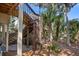 Wooden stairs leading to the backyard, complemented by lush greenery, plants, and mulch ground cover at 1409 Dune Loft Villas, Seabrook Island, SC 29455