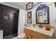 A bathroom featuring a vanity with a framed mirror and a dark tiled shower at 1409 Dune Loft Villas, Seabrook Island, SC 29455