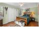 Cozy bedroom featuring wood bed frame, decorative bench, ceiling fan, and closet at 1409 Dune Loft Villas, Seabrook Island, SC 29455