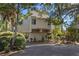 Inviting raised beach home featuring neutral siding and lush landscaping at 1409 Dune Loft Villas, Seabrook Island, SC 29455