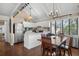Bright kitchen features white cabinets, stainless appliances, eat-in island, and wood dining table at 1409 Dune Loft Villas, Seabrook Island, SC 29455