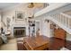 Bright living room with a fireplace, hardwood floors, and stairway access at 1409 Dune Loft Villas, Seabrook Island, SC 29455
