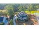 Aerial view of stunning home with a long driveway and overlooking a serene pond surrounded by trees at 1427 Shell Fish Ct, Mount Pleasant, SC 29466