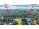 Overhead view featuring an inground pool, waterfront and surrounding residential homes in a lush landscape at 1427 Shell Fish Ct, Mount Pleasant, SC 29466