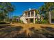 Beautiful backyard featuring the home with a screened in porch, patio, and green lawn at 1427 Shell Fish Ct, Mount Pleasant, SC 29466