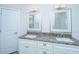 Well-lit bathroom with granite countertops, dual sinks, and matching mirrors at 1427 Shell Fish Ct, Mount Pleasant, SC 29466