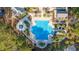 Aerial view of a community pool surrounded by palm trees with plenty of seating and water slide at 1427 Shell Fish Ct, Mount Pleasant, SC 29466