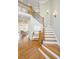 Elegant foyer with wood staircase and hardwood floors, leading into the living room at 1427 Shell Fish Ct, Mount Pleasant, SC 29466