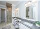 Luxurious main bathroom featuring dual vanities, granite counters, a glass shower, and a separate soaking tub at 1427 Shell Fish Ct, Mount Pleasant, SC 29466