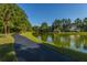 Picturesque walking path alongside a serene lake with beautiful homes in the background at 1427 Shell Fish Ct, Mount Pleasant, SC 29466