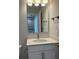 Bright bathroom features modern vanity with white countertop and cabinet, and a large mirror at 143 Cantona Dr, Summerville, SC 29483