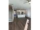 Open-concept living space with modern kitchen, sleek flooring, and a staircase at 143 Cantona Dr, Summerville, SC 29483