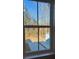 Window with white trim looking out to trees and partial view of a house with blue siding at 143 Cantona Dr, Summerville, SC 29483