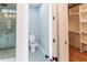 Well designed bathroom leads to walk in closet and features geometric floor tiles, shower, and toilet at 143 Harvest Way, Walterboro, SC 29488