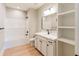 Bright bathroom with a bathtub/shower combo, white vanity, and a large mirror and shelves at 143 Harvest Way, Walterboro, SC 29488