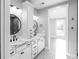 Bright bathroom featuring a double vanity, decorative floor tiles, and round mirrors at 143 Harvest Way, Walterboro, SC 29488