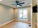 This bright bedroom features a ceiling fan, hardwood floors and a large window at 143 Harvest Way, Walterboro, SC 29488