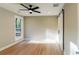 Inviting bedroom featuring hardwood floors, natural light from a window, and a stylish sliding barn door at 143 Harvest Way, Walterboro, SC 29488