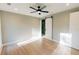 Bright bedroom featuring light wood floors, a modern ceiling fan, and a barn door leading to the bathroom at 143 Harvest Way, Walterboro, SC 29488