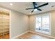 A bright bedroom boasts a ceiling fan, hardwood floors, a large window, and a walk-in closet at 143 Harvest Way, Walterboro, SC 29488
