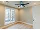 A bright bedroom features a ceiling fan, hardwood floors and a large window at 143 Harvest Way, Walterboro, SC 29488