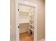 Organized walk-in closet with built-in shelving, a hanging rod and hardwood floors at 143 Harvest Way, Walterboro, SC 29488
