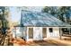 Side exterior featuring a modern home, a metal roof, and the verdant landscaping and woods surrounding the house at 143 Harvest Way, Walterboro, SC 29488