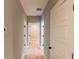 Hallway featuring hardwood floors, white trim and doors, and neutral colored walls at 143 Harvest Way, Walterboro, SC 29488
