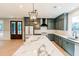 Modern kitchen features a marble island, stainless steel appliances, and gray cabinets at 143 Harvest Way, Walterboro, SC 29488