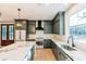 Bright kitchen features gray cabinetry, stainless steel appliances, and a large island for entertaining at 143 Harvest Way, Walterboro, SC 29488